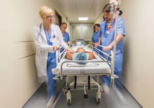 Wheeling patient down hallway